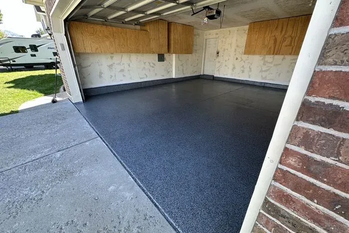 Dark flake epoxy garage floor in Washington Utah by Nichols Concrete Sealing