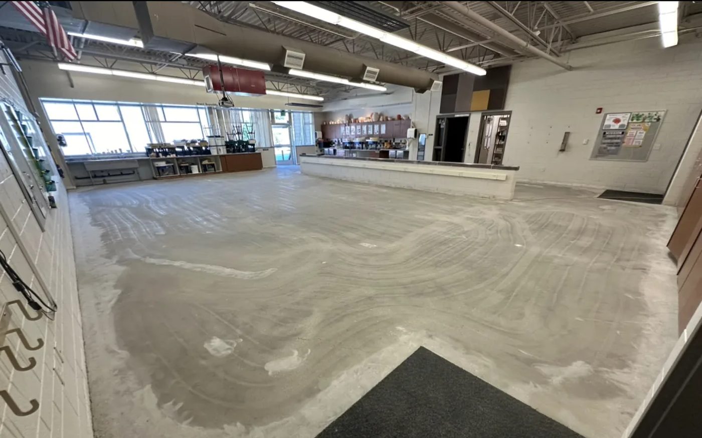 Shot blast surface prep in progress — mechanical concrete profiling